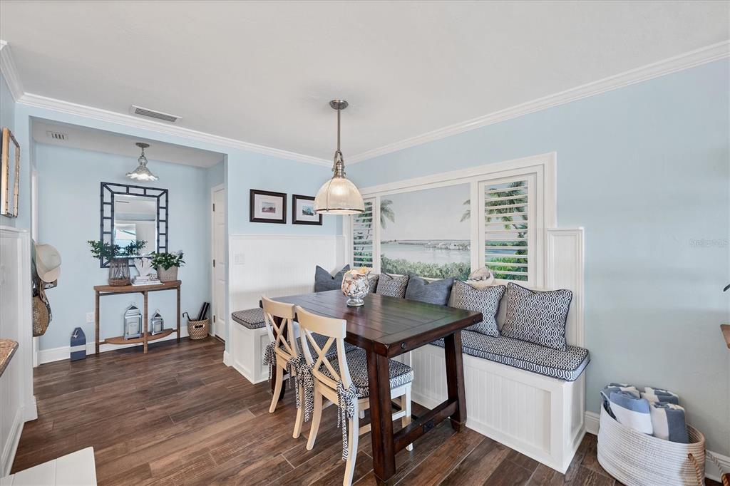 5854 Gasparilla Road, Unit MV20 Boca Grande, FL 33921 - Photo 8 of 49 a dining room with furniture a chandelier and wooden floor