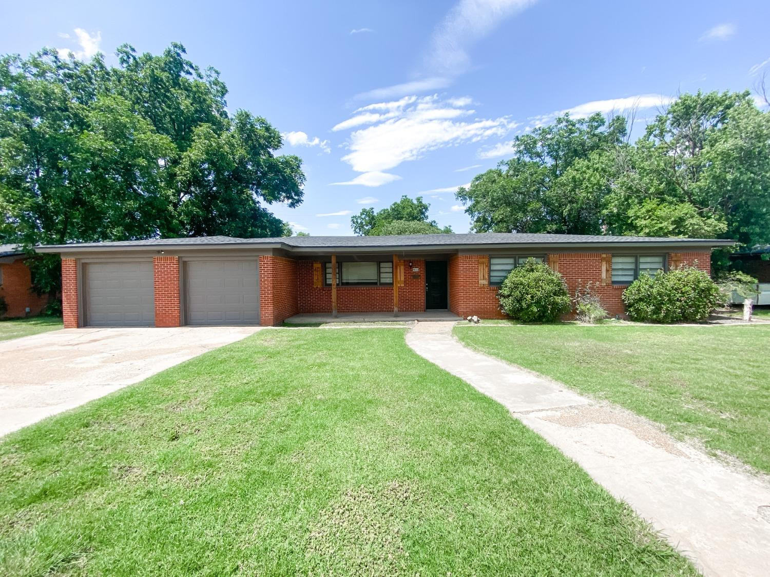 4010 47th Street Lubbock, TX 79413 - Photo 1 of 20 front view of a house with a yard