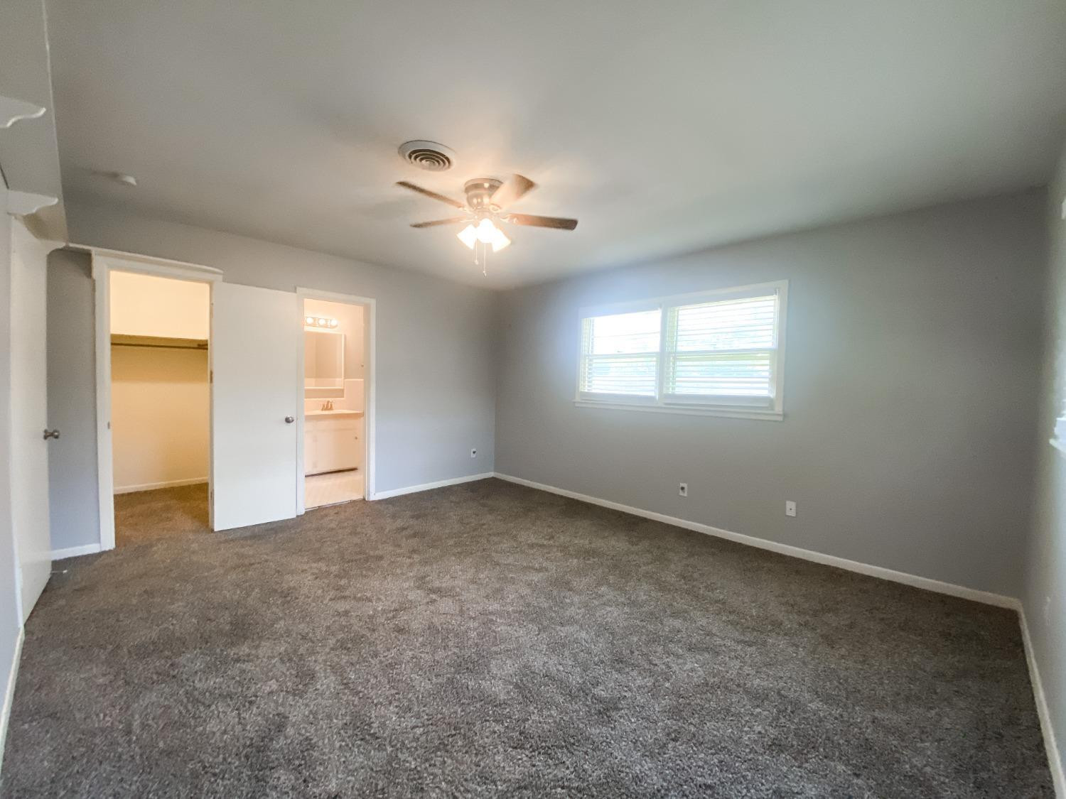 4010 47th Street Lubbock, TX 79413 - Photo 12 of 20 wooden floor in an empty room with a window