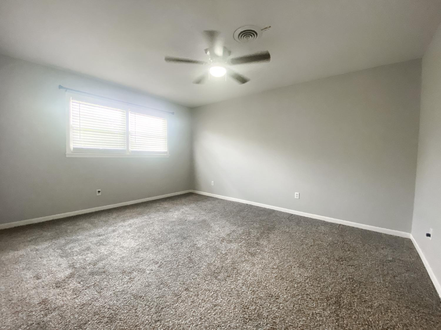 4010 47th Street Lubbock, TX 79413 - Photo 16 of 20 an empty room with a empty space and windows