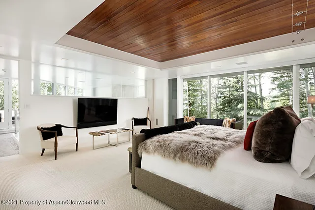 a living room with furniture and a floor to ceiling window