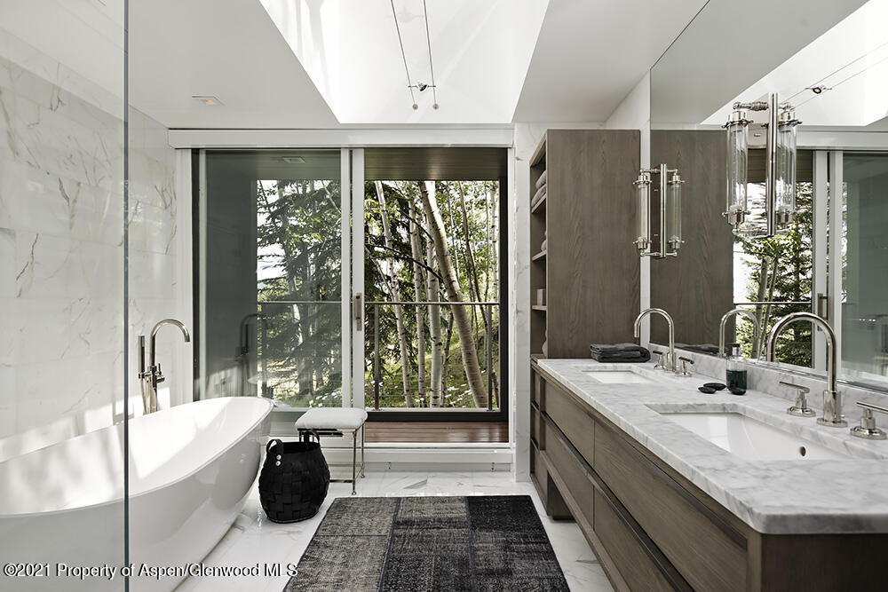 546 Edgewood Lane Snowmass Village, CO 81615 - Photo 18 of 60 a bathroom with a double vanity sink and large mirror