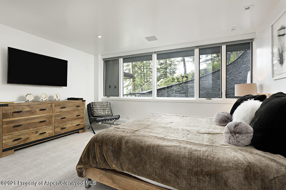 546 Edgewood Lane Snowmass Village, CO 81615 - Photo 20 of 60 a bedroom with a bed and a flat screen tv