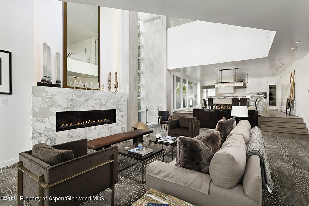 546 Edgewood Lane Snowmass Village, CO 81615 - Photo 3 of 60 a living room with furniture kitchen view and a fireplace