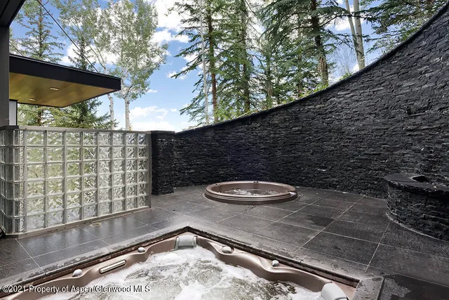 a living room with furniture and a gym machine