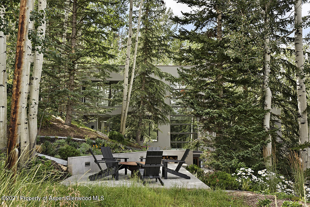 546 Edgewood Lane Snowmass Village, CO 81615 - Photo 34 of 60 a view of a patio with table and chairs and potted plants