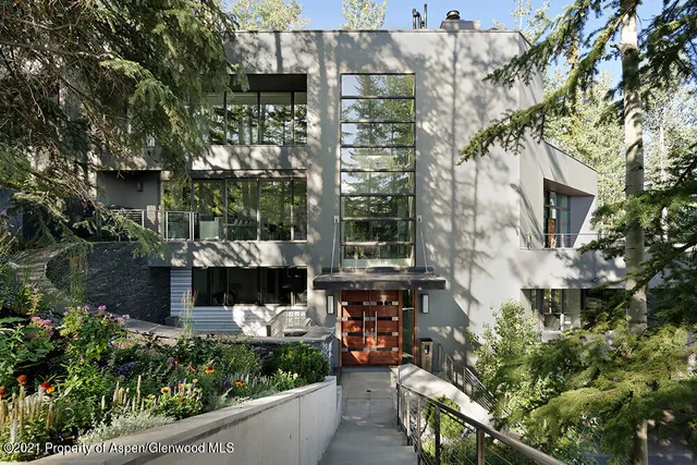 a view of a roof deck with table and chairs a barbeque with wooden floor and fence