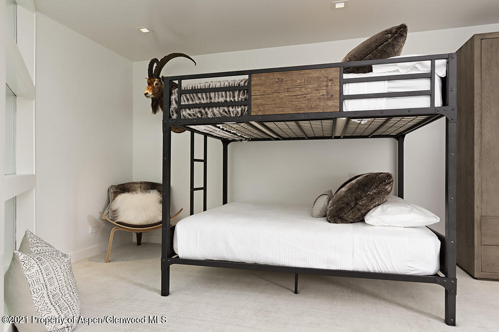 546 Edgewood Lane Snowmass Village, CO 81615 - Photo 43 of 60 a bedroom with a bed and a chandelier