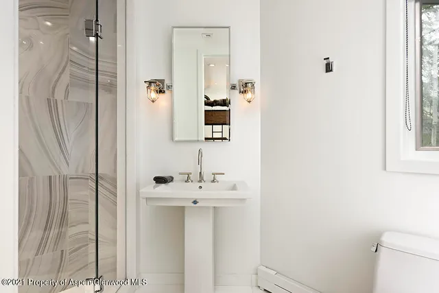 a living room with furniture large window and a fireplace