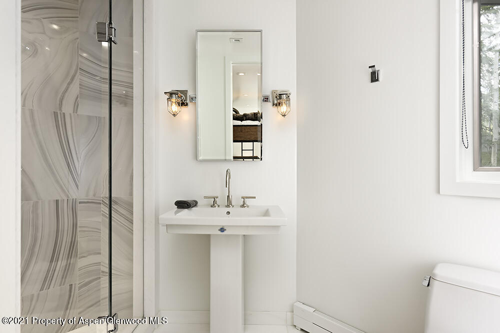 546 Edgewood Lane Snowmass Village, CO 81615 - Photo 44 of 60 a bathroom with a sink a mirror and a shower