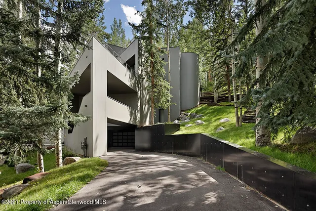a backyard of a house with fire pit and outdoor seating