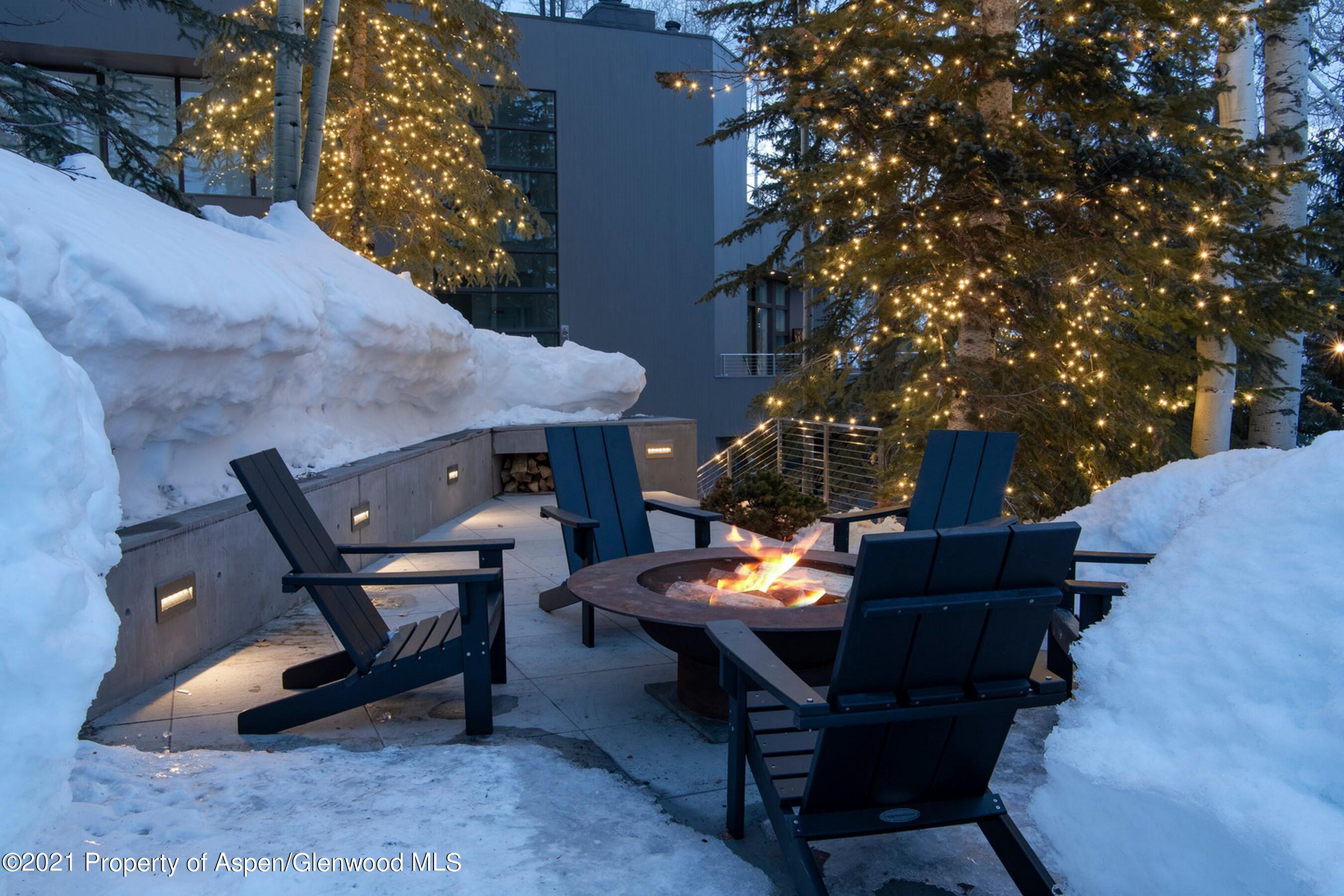 546 Edgewood Lane Snowmass Village, CO 81615 - Photo 59 of 60 a backyard of a house with fire pit and outdoor seating