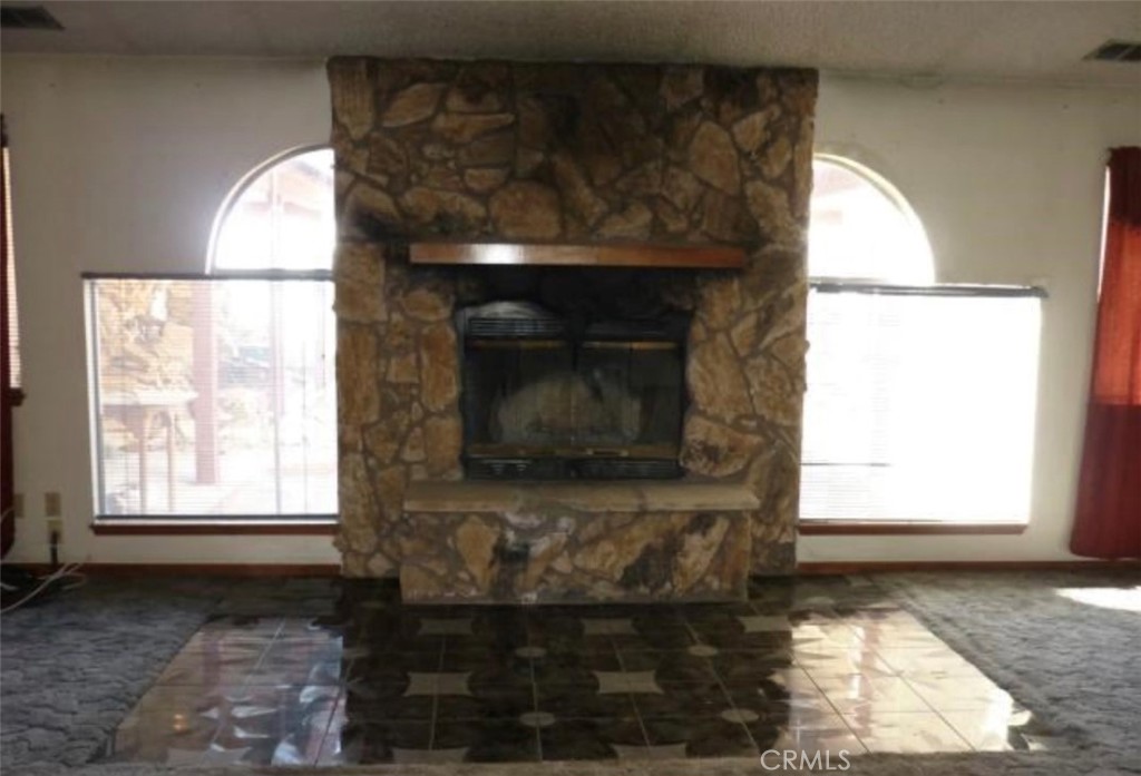 6888 Bookasta Street Adelanto, CA 92301 - Photo 11 of 19 a living room with a fireplace and a window