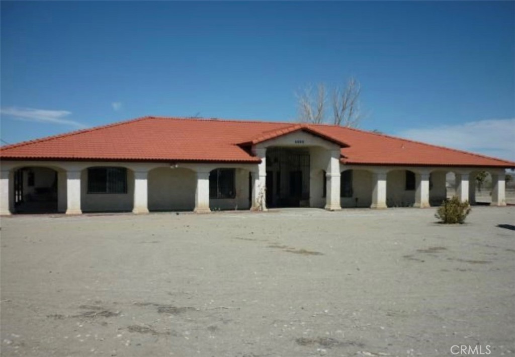 6888 Bookasta Street Adelanto, CA 92301 - Photo 2 of 19 a front view of a house with a yard