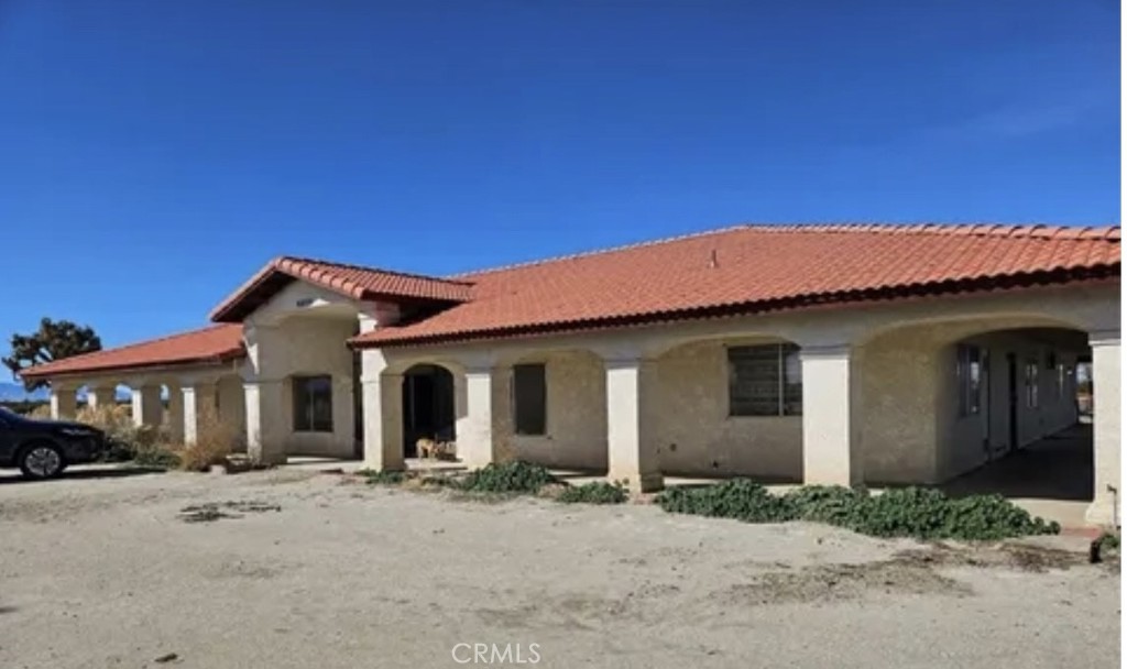 6888 Bookasta Street Adelanto, CA 92301 - Photo 4 of 19 a front view of a house with a yard