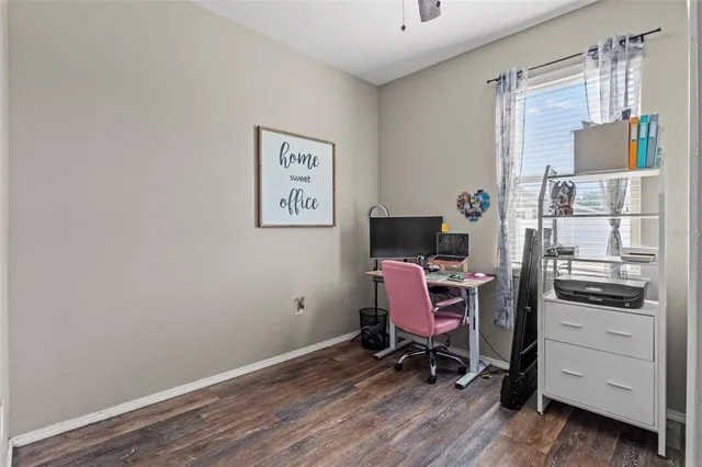 a view of a workspace with furniture and a window