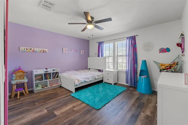 a bedroom with a bed and a book shelf
