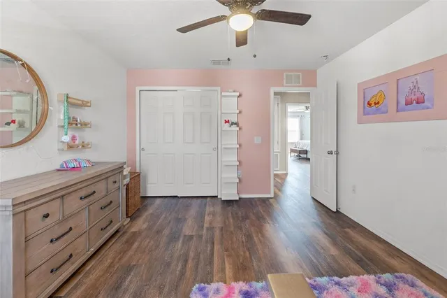 an entryway with wooden floor and cabinet
