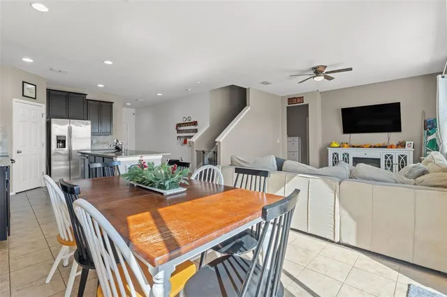 a view of a dining room with furniture a rug and wooden floor