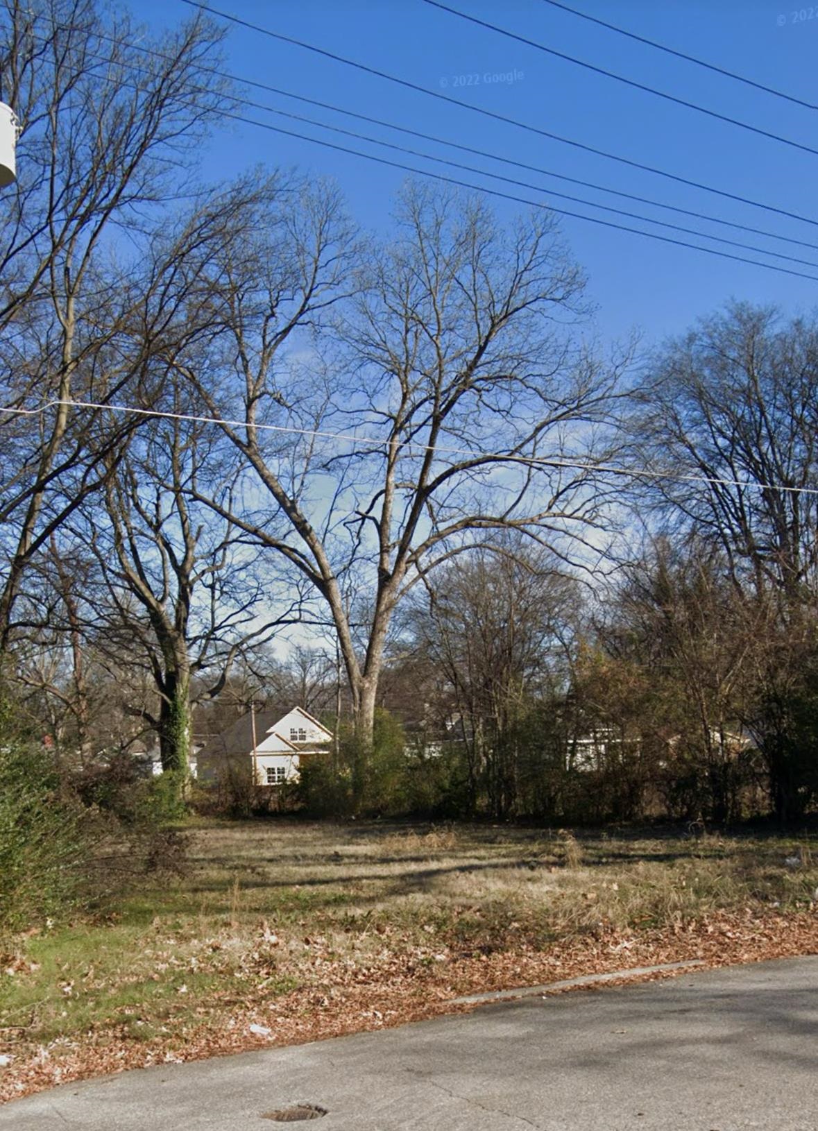 a view of a yard with a house in the background