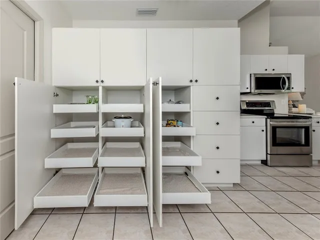 a view of bedroom with cabinets and window