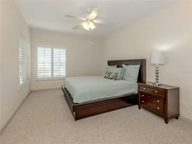 a spacious bedroom with a bed and a chandelier