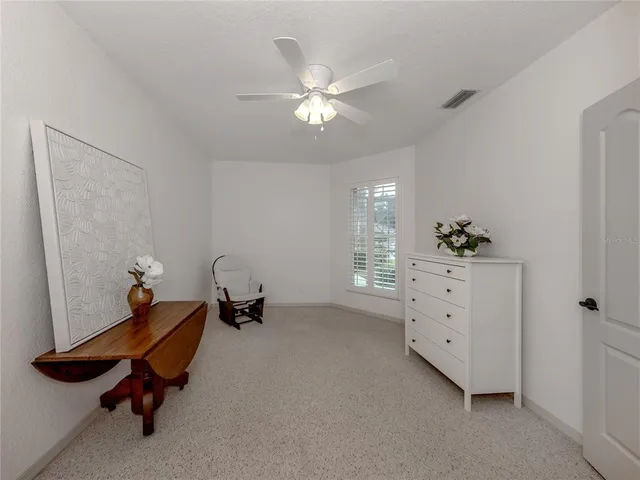a room with gym equipment and wooden floor