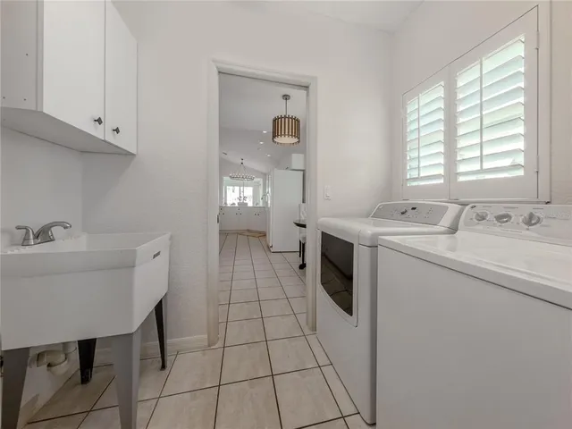 a spacious bathroom with sink shower and mirror