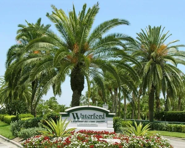 a view of a sign under a tree