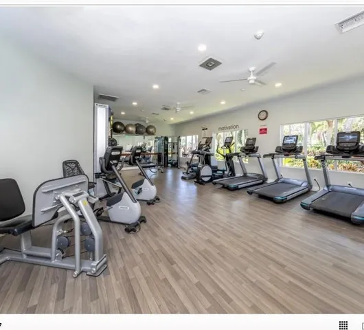 a living room with lots of furniture and wooden floor