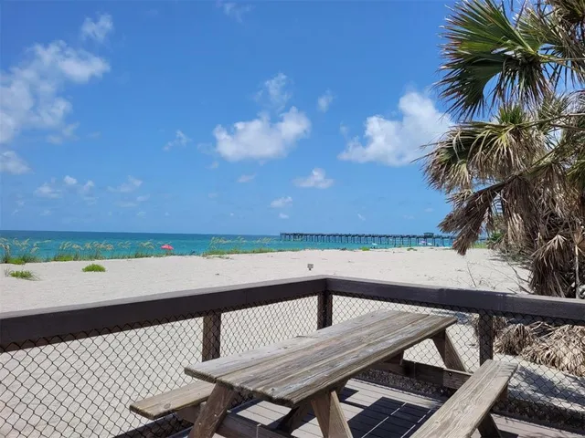 a view of wooden floor and a floor to ceiling window