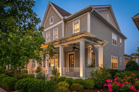 a front view of a house with plants