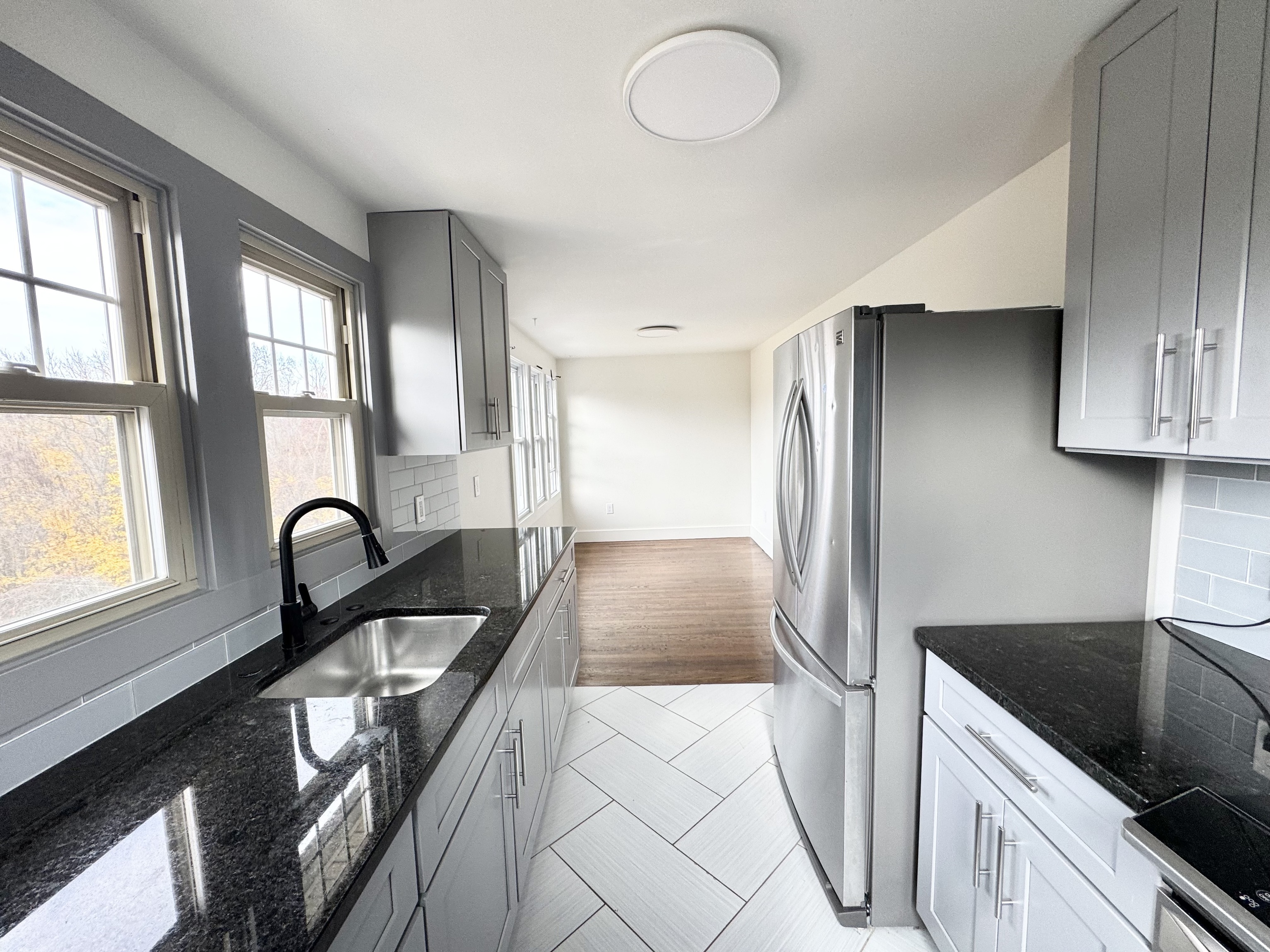 a kitchen with granite countertop a stove and a sink