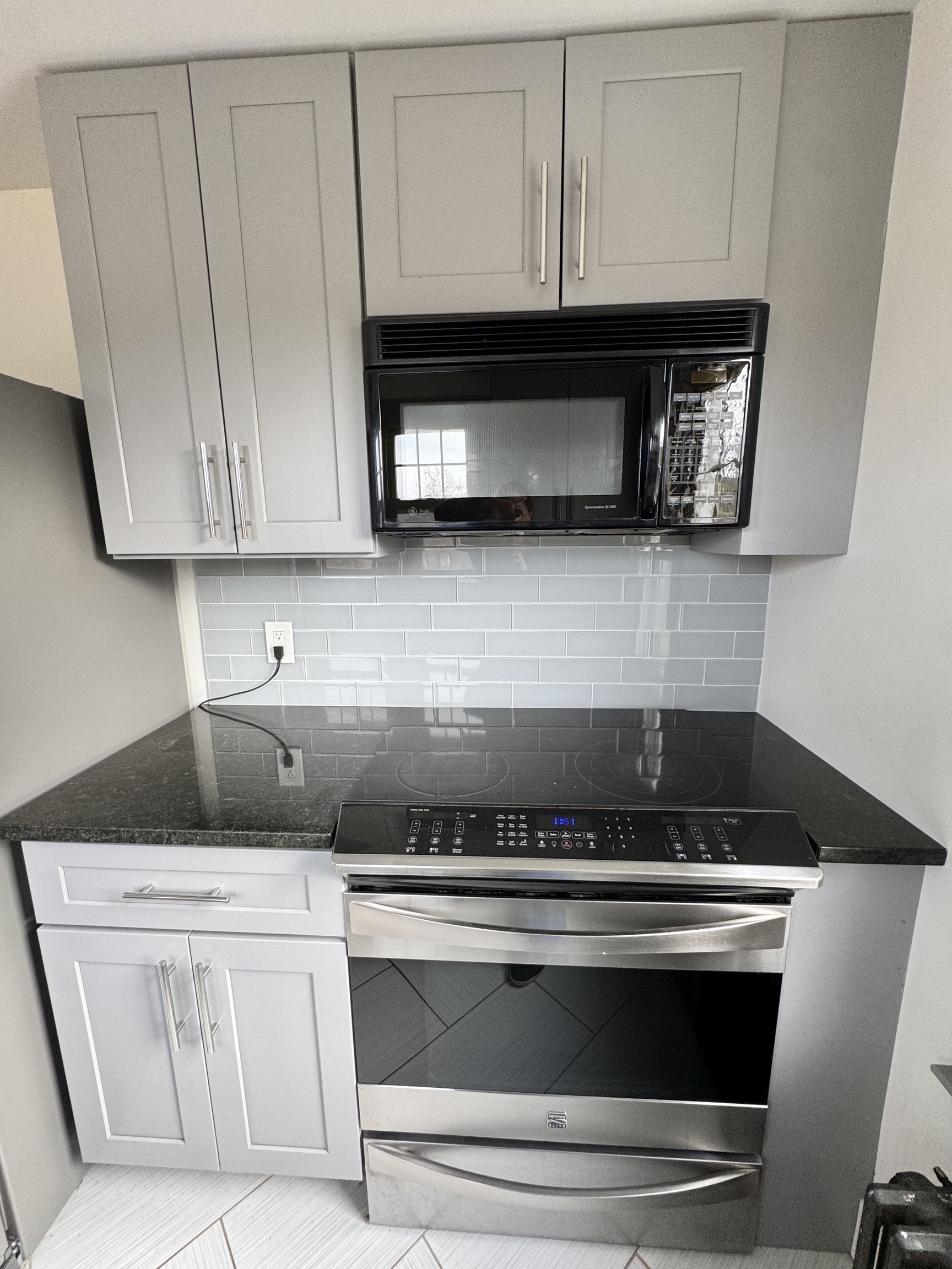 162 High Street Naugatuck, CT 06770 - Photo 12 of 25 a kitchen with white cabinets and black appliances