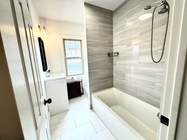 a bathroom with a tub and a shower
