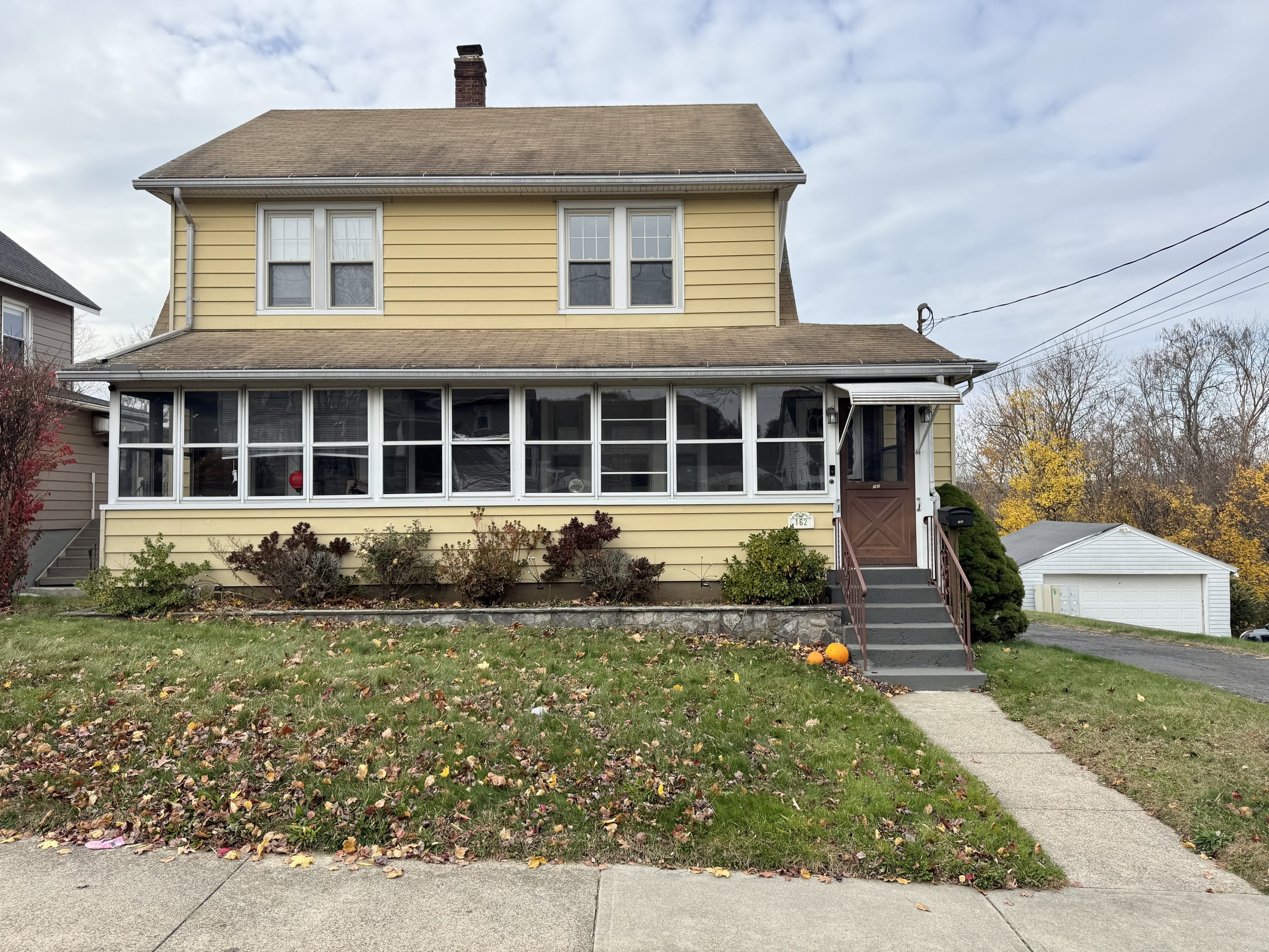 162 High Street Naugatuck, CT 06770 - Photo 4 of 25 a front view of a house with a yard