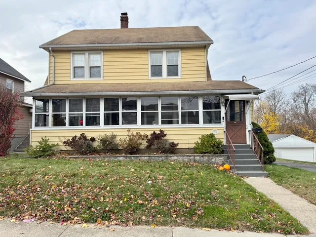 a front view of a house with a garden