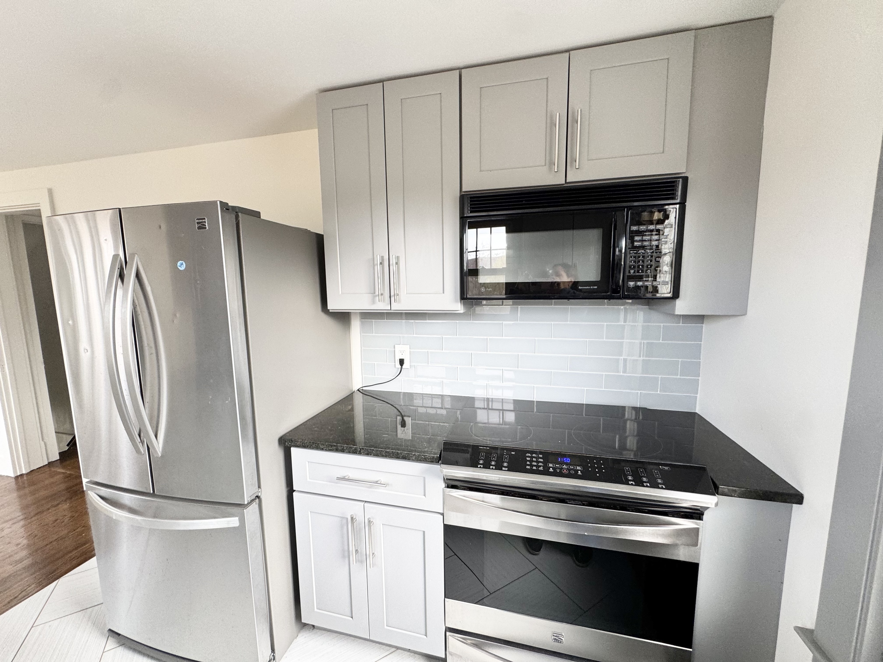 162 High Street Naugatuck, CT 06770 - Photo 7 of 25 a kitchen with granite countertop white cabinets and stainless steel appliances