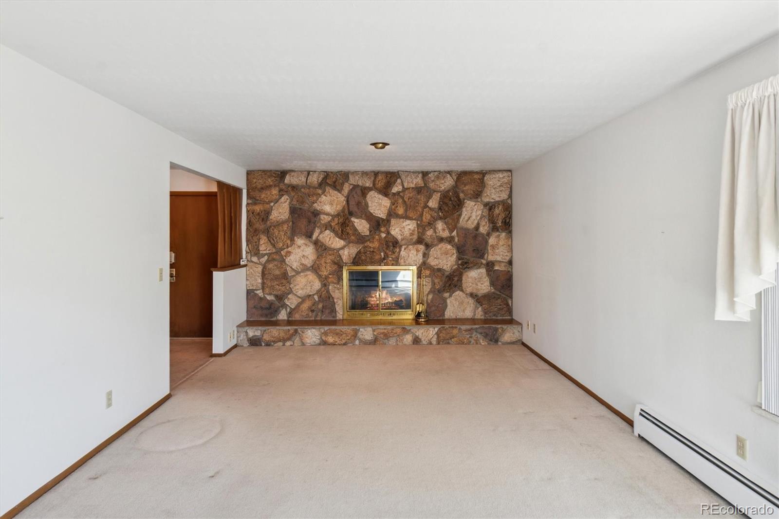 20 Rangeview Place Wheat Ridge, CO 80215 - Photo 12 of 49 an empty room with fireplace and window