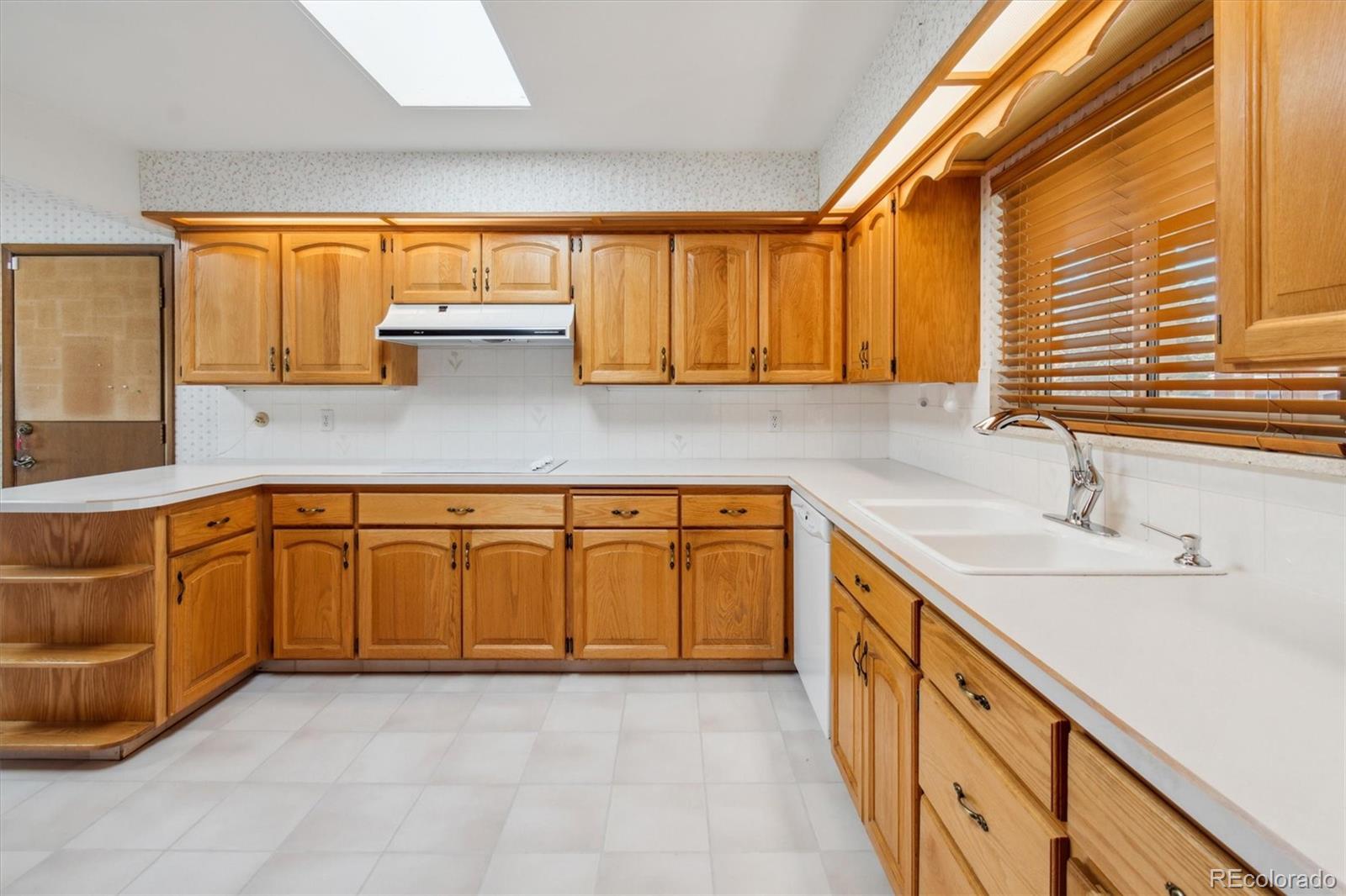 20 Rangeview Place Wheat Ridge, CO 80215 - Photo 14 of 49 a kitchen with granite countertop a sink a stove and cabinets