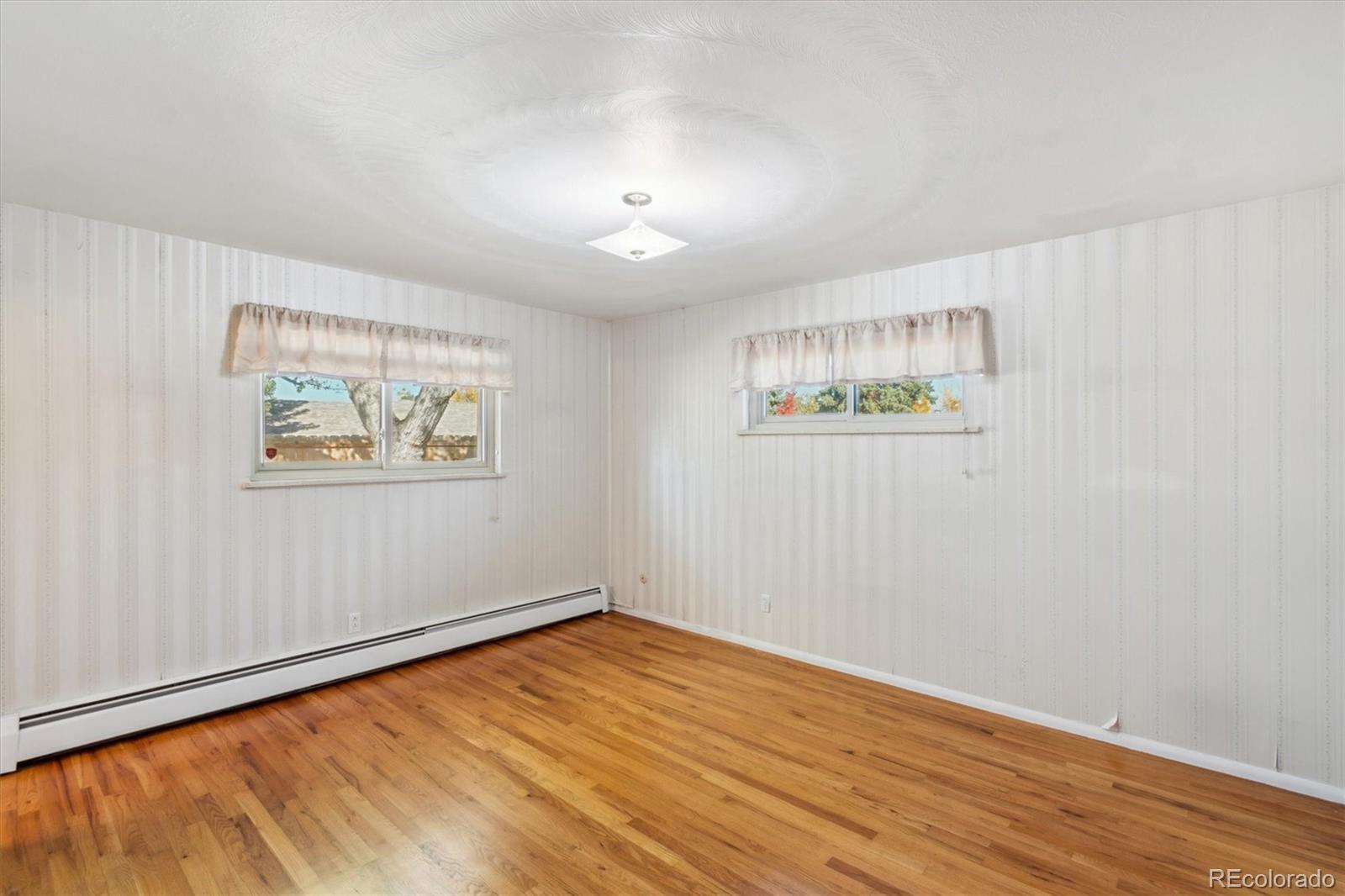 20 Rangeview Place Wheat Ridge, CO 80215 - Photo 18 of 49 a view of an empty room with wooden floor