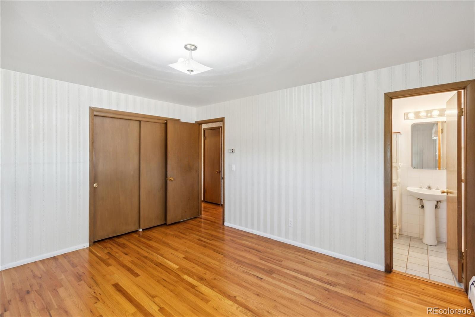 20 Rangeview Place Wheat Ridge, CO 80215 - Photo 19 of 49 an empty room with wooden floor and windows