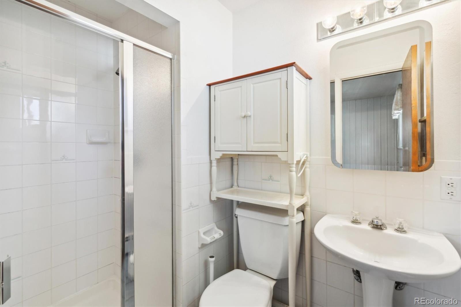 20 Rangeview Place Wheat Ridge, CO 80215 - Photo 20 of 49 a bathroom with a sink toilet and mirror