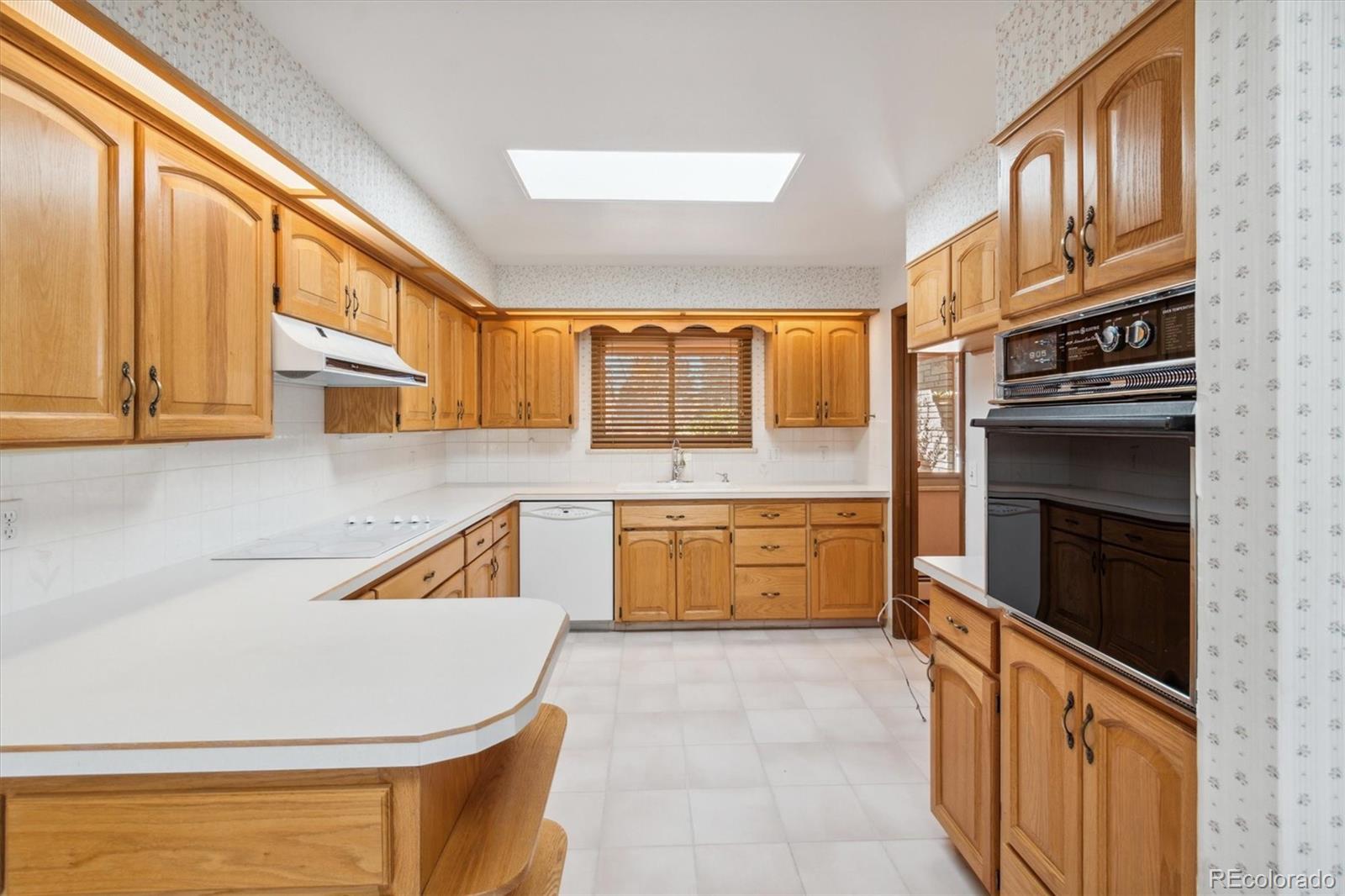 20 Rangeview Place Wheat Ridge, CO 80215 - Photo 2 of 49 a kitchen with stainless steel appliances granite countertop a stove and a sink