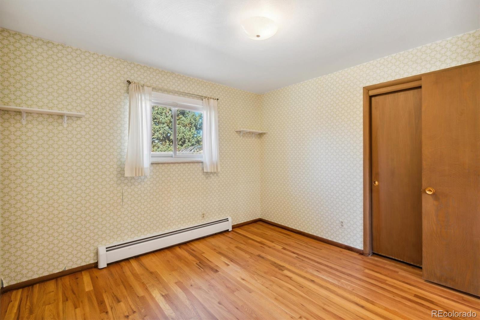 20 Rangeview Place Wheat Ridge, CO 80215 - Photo 21 of 49 a view of empty room with wooden floor and fan