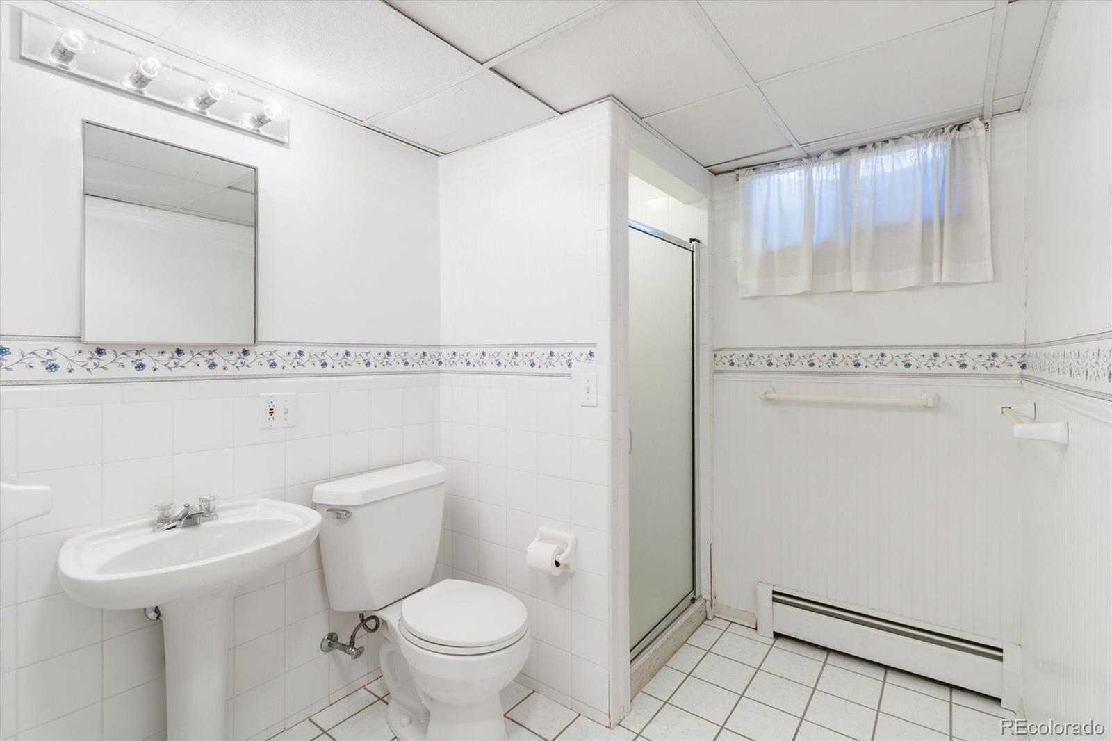 20 Rangeview Place Wheat Ridge, CO 80215 - Photo 22 of 49 a bathroom with a sink toilet and shower