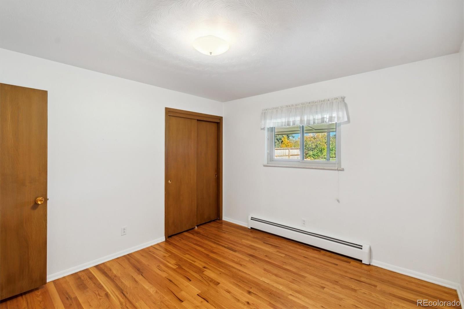 20 Rangeview Place Wheat Ridge, CO 80215 - Photo 29 of 49 a view of empty room with wooden floor