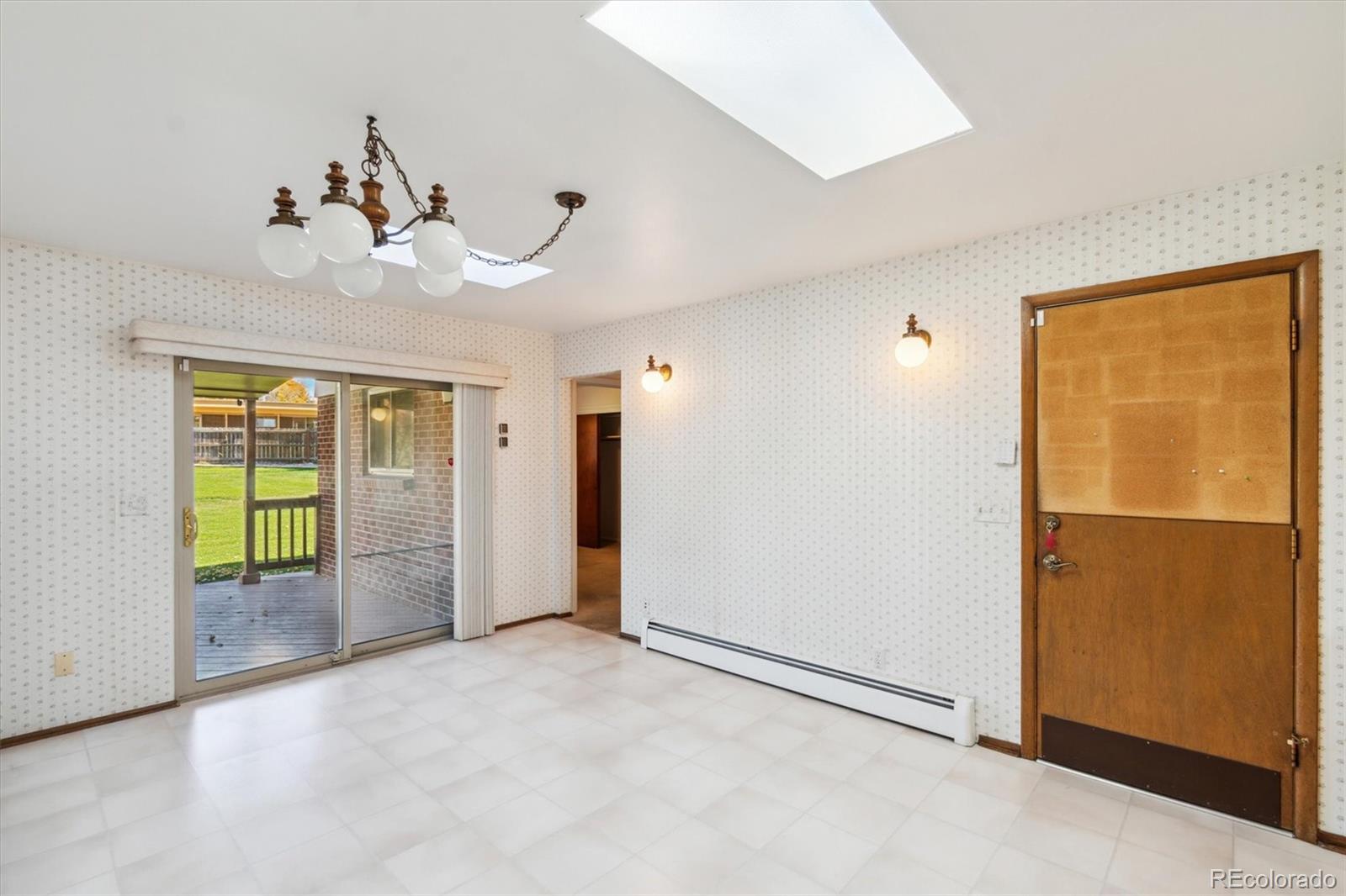 20 Rangeview Place Wheat Ridge, CO 80215 - Photo 3 of 49 an empty room with chandelier fan and glass door