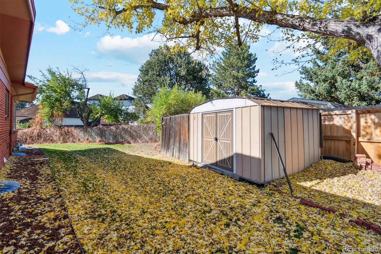 20 Rangeview Place Wheat Ridge, CO 80215 - Photo 36 of 49 a view of a backyard with potted plants and large tree