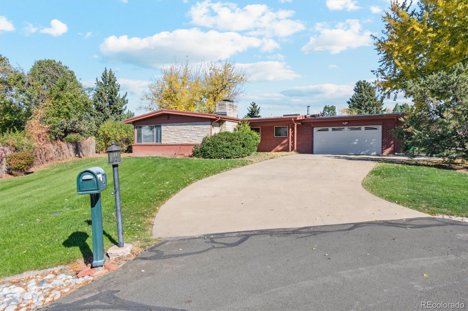 20 Rangeview Place Wheat Ridge, CO 80215 - Photo 6 of 49 a front view of a house with a yard and garage